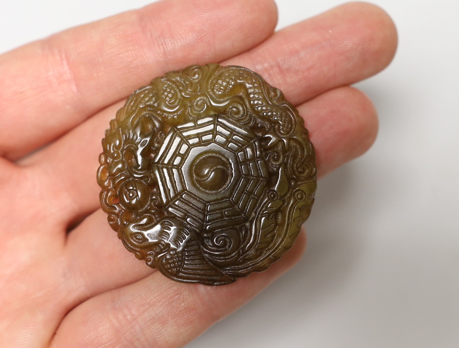 Three Chinese carved hardstone pendants